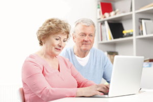 Senior couple using a laptop PC together